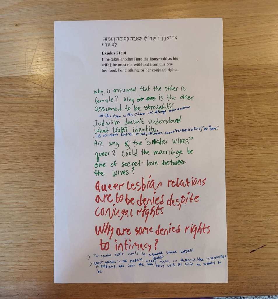 A sheet of tabloid-sized paper with a passage from the Torah printed on it, plus written commentary.