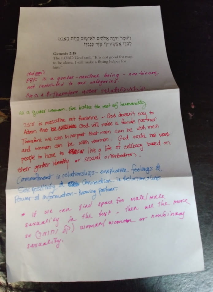 Printout of Genesis 2:18 with commentary written in different colors.