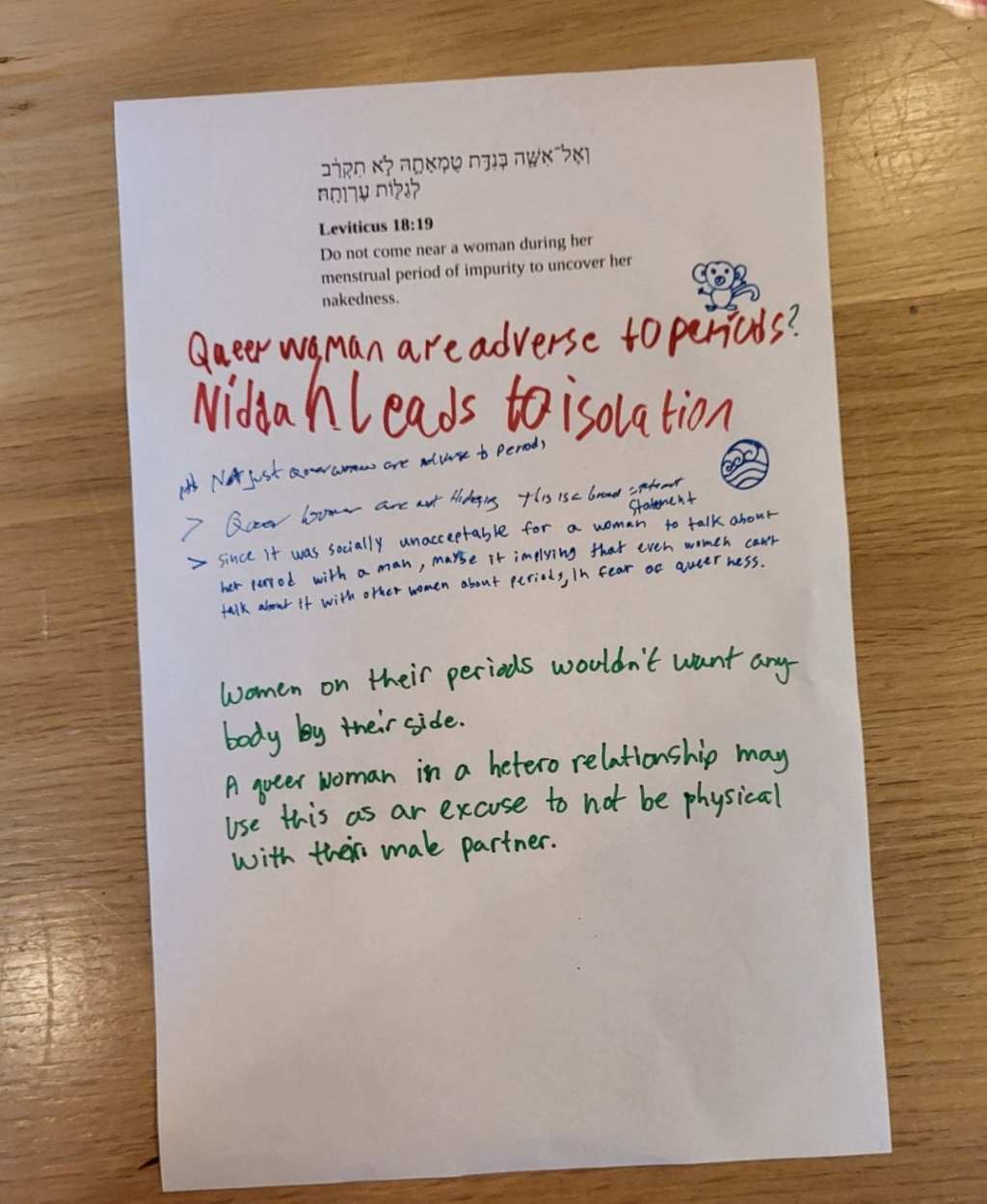 A sheet of tabloid-sized paper with a passage from the Torah printed on it, plus written commentary.